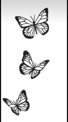 three black and white butterflies flying in the air