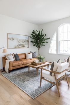 a living room filled with furniture and a potted plant on top of a table