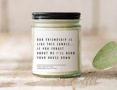 a candle with a quote on it sitting next to a leaf that says, our friend is like this candle if you forget about me i'll burn your house down