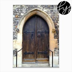 an old stone building with two wooden doors