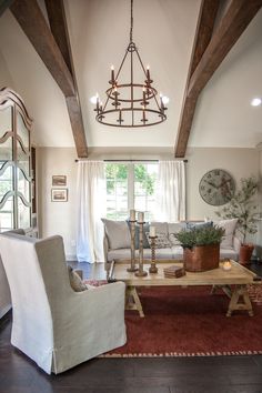 a living room filled with furniture and a chandelier