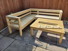 a wooden bench sitting next to a table