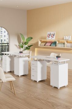 an office with white furniture and wooden floors