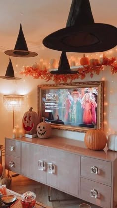 a living room decorated for halloween with decorations on the wall and lights hanging from the ceiling