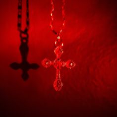 a red light with a cross on it and a chain hanging from the ceiling in front of it