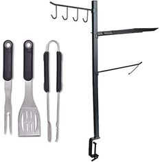 an assortment of kitchen utensils hanging on a rack with hooks and tongs