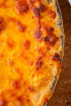 a cheesy pizza sitting on top of a pan