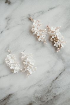 Elsie Earrings Elegant and airy, these romantic bridal earrings will take your breath away. Light ivory clay flowers and freshwater pearls are hand strung to trailing branches. Finished with a crystal stud closure, these are sure to add the perfect touch to your bridal look. These ornate drop earrings are extremely lightweight making them extremely comfortable to wear all day and night long. Available in Silver and Gold. Our earrings, necklaces and bracelets are lead, nickel and cadmium free. Th Delicate Wedding Pearl Earrings With Flower Charm, Delicate Pearl White Flower Earrings, Delicate Pearl Earrings With Flower Charm For Wedding, Wedding Pearl Earrings With Flower Charm, Delicate Flower Pearl Earrings For Wedding, White Pearl Flower Earrings, Pearl Earrings With Flower Charm For Wedding, Delicate White Bridal Earrings, Pearl Flower Wedding Earrings