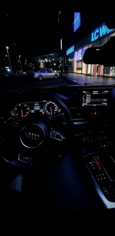 the interior of a car at night with its dashboard lights on and dash lights lit up