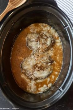 a slow cooker filled with meat and gravy