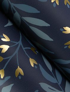 a blue and gold wallpaper with leaves on the side, it is very dark