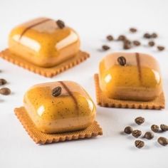 three pieces of cake sitting on top of each other next to some coffee beans and seeds