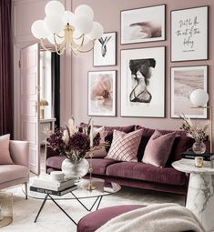 a living room filled with purple furniture and pictures on the wall above it's coffee table