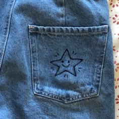 a blue jean skirt with a star drawn on it