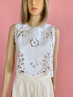 "A lovely, goes-with-everything cropped tank top made with our beautiful Lim's Vintage signature Battenberg lace fabric. Pair it with jeans, boots, or a short or long skirt. This is a one-of-a-kind item that you will treasure forever.  Measurements: Small:  Bust: 36.5\" Length: 17\" Medium:  Bust: 38.5\" Length: 17\" Large:  Bust: 40.5\" Length: 18\"  Color: White   Material: 100% cotton" Spring Lace Patchwork Sleeveless Crop Top, Spring Sleeveless Lace Patchwork Crop Top, Sleeveless Lace Patchwork Crop Top For Spring, Sleeveless Lace Patchwork Crop Top, Spring Cropped Top With Scalloped Lace, Spring Cropped Tops With Scalloped Lace, Spring Scalloped Lace Cropped Tops, Fitted Lace Top With Crochet Trim, Lace Patchwork Crop Top