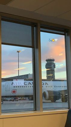 an airplane is seen through the windows of an airport