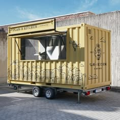 a yellow shipping container sitting on top of a brick floor next to a building with windows