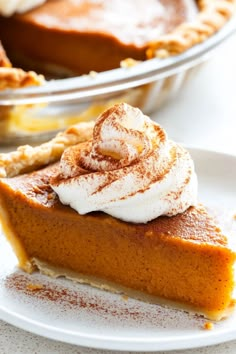 a slice of pumpkin pie with whipped cream on top