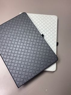 two black and white mats sitting on top of each other