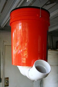 a red and white bucket hanging from the ceiling