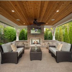 an outdoor living area with couches and tables