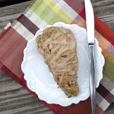 a piece of pie on a plate with a fork next to it and a napkin