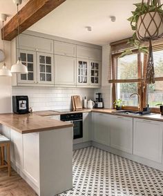 a kitchen with white cabinets and black and white checkered flooring on the tile