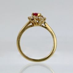 A wonderful cocktail ring by Kurt Wayne.  In 18K yellow gold with a half-twist to the shank. The shank supports a gallery with a central pear-cut ruby and 10 small round cut diamonds.   A high-level ring from the famous New York jewelry designer!  Marked to the shank 750 for 18k gold fineness and with a conjoined KW for Kurt Wayne.  Ring Size: ca. 5 1/2  Dimensions reference the ring size and are not specific to the ring itself. Gold Marquise Cut Ruby Diamond Ring, Yellow Gold Pear-shaped Ruby Ring, Pear-shaped Ruby Ring With Diamond Halo Setting, Pear-shaped Ruby Ring With Diamond Halo, Gold Ruby Ring With Marquise Center Stone, Gold Ruby Marquise Ring With Center Stone, Gold Ruby Cluster Ring With Halo Setting, Formal Gold Pear-shaped Ruby Ring, Pear-shaped Gold Ruby Ring With Diamonds