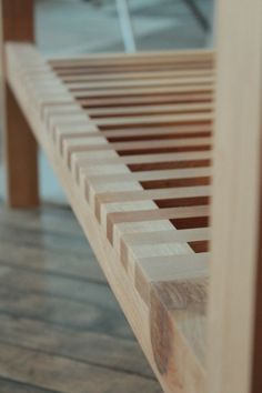 a close up view of a wooden bench with slats on the top and bottom