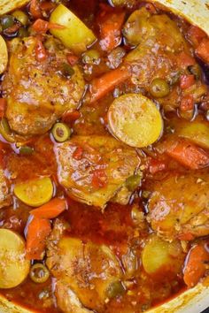 a pot filled with meat and vegetables on top of a stove