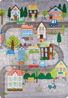 a child's rug with houses, cars and trucks on the road in front of them