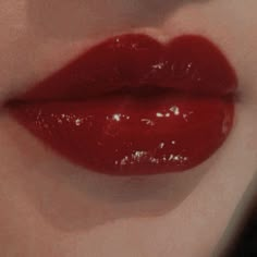 a woman's lips with red liquid on them