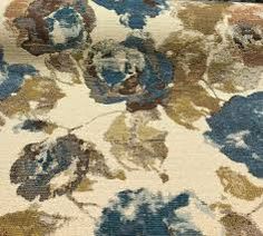 an area rug with blue and brown flowers on it