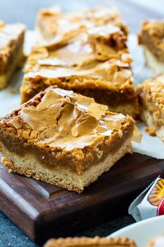 peanut butter bars on a wooden cutting board