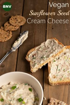 a bowl of cream cheese next to crackers on a wooden table with the words vegan sunflower seed cream cheese