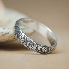 two wedding rings sitting next to each other on top of a piece of paper with the words moonlight designs written in it