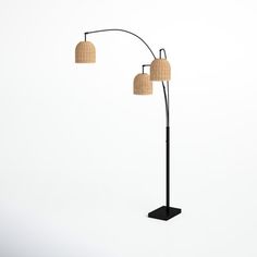 three light floor lamp with beige shades on the lampshade and two round shades on the lightshades