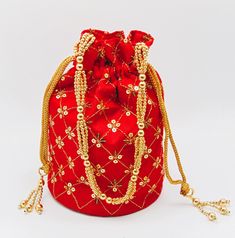 "Handmade ethnic Indian designer potli batva bags with a draw string, delicately hand-embroidered according to your taste and style. You can match it with any traditional outfit or use it as a return gift in weddings favor for guests, bride's maid. Wholesale price discount of up to 50 percent if purchased in bulk (10 pieces are more. Use promo code \"BULK50\"). Chat with us for any queries. We offer many different designs of potli bags to choose from. See our page for more of our collection! We Bohemian Multicolor Potli Bag For Diwali, Red Bag With Zari Work For Festivals, Festive Red Embroidered Bag, Festive Red Shoulder Bag With Handwork, Red Embroidered Potli Bag For Party, Festival Multicolor Embroidery Potli Bag With Zari Work, Festive Multicolor Embroidered Potli Bag With Handwork, Festive Multicolor Embroidered Handwork Potli Bag, Festive Multicolor Embroidered Potli Bag