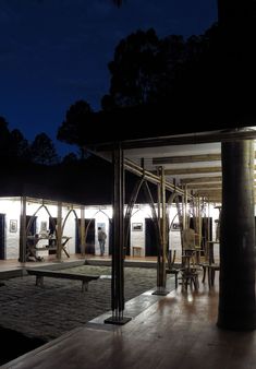 an outdoor area with tables and chairs at night