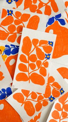 several orange and blue flowers on white paper