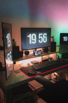 two computer monitors sitting on top of a desk in front of a keyboard and mouse