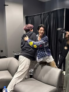 two people hugging each other in front of a mirror