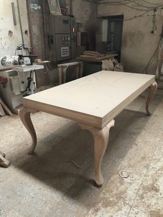 an old table is being worked on in a shop