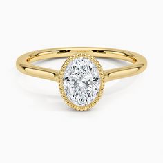 a yellow gold ring with a oval cut diamond