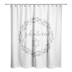 a white shower curtain with the word shalonn on it and an olive wreath