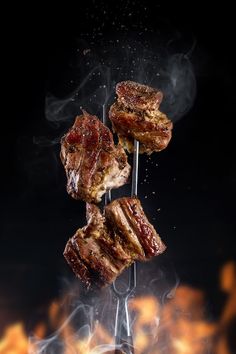 some meat is being grilled on a skewer