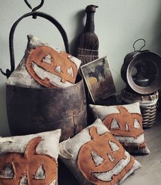 three pumpkin pillows sitting on top of a wooden table