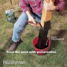 a man sitting in the grass with a wooden pole sticking out of it's mouth