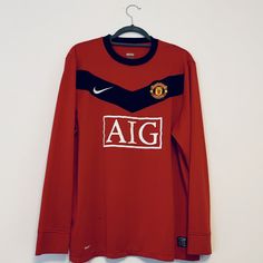 an old manchester united shirt hanging on a hanger with the word'aig'written across it