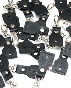 a bunch of black leather pieces with chains attached to them